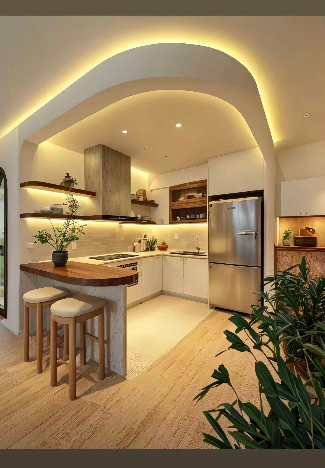 Compact modern kitchen remodel with curved opening and warm ambient lighting